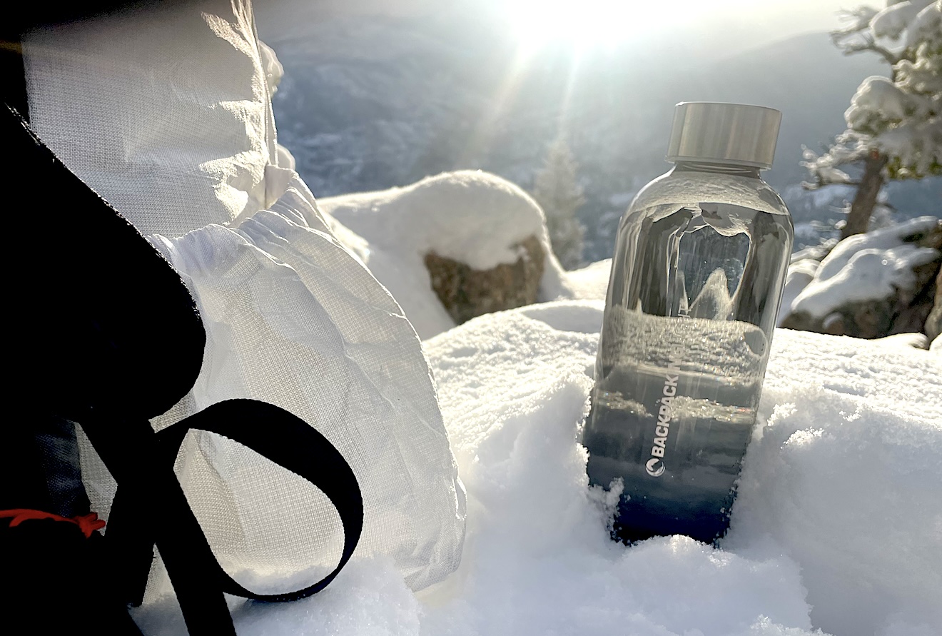 a bottle of water sitting in the snow