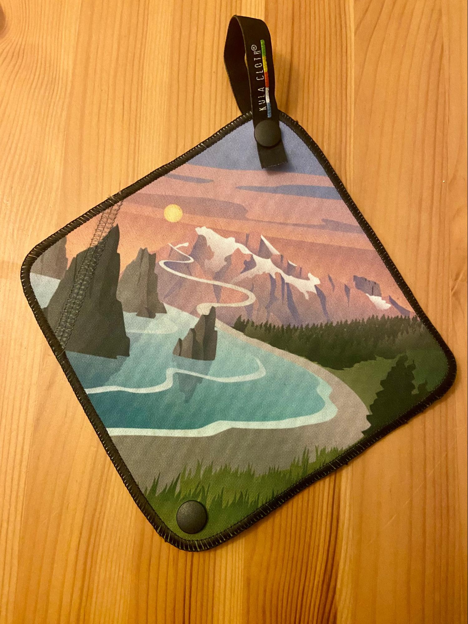 a place mat with a picture of a lake and mountains on it