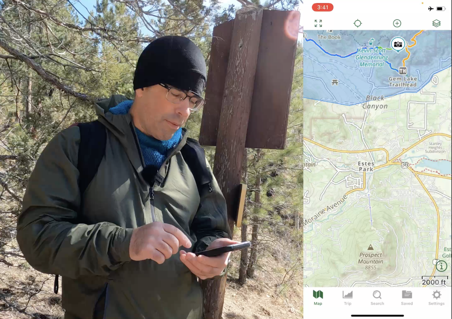 a man looks at a phone on one side of the screen. On the other, a map. 