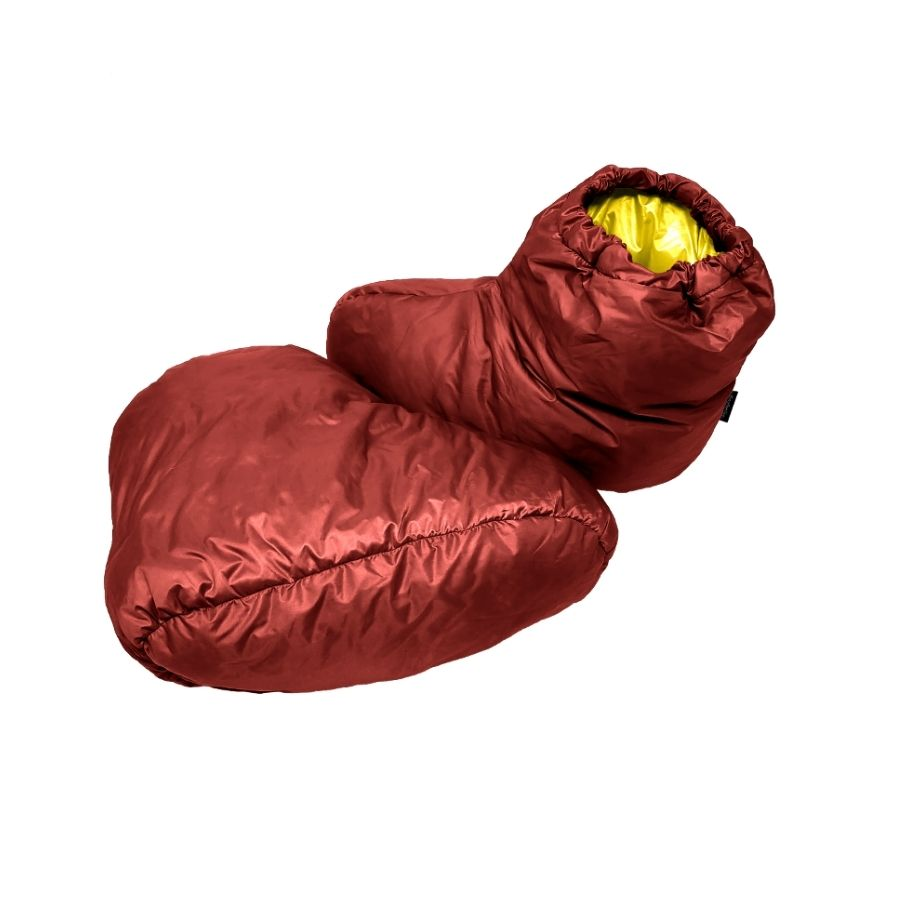 a red sleeping bag with a yellow ball in it